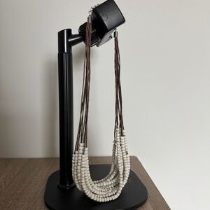 Boho hippie cream colored beaded necklace on brown